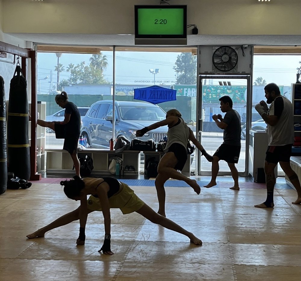 Strikers Inc. class warming up and stretching before training in San Gabriel